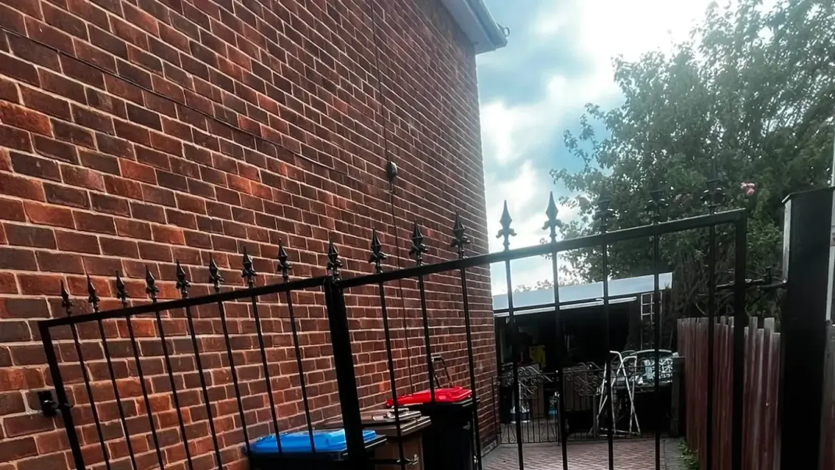 Double wrought iron driveway gates painted black