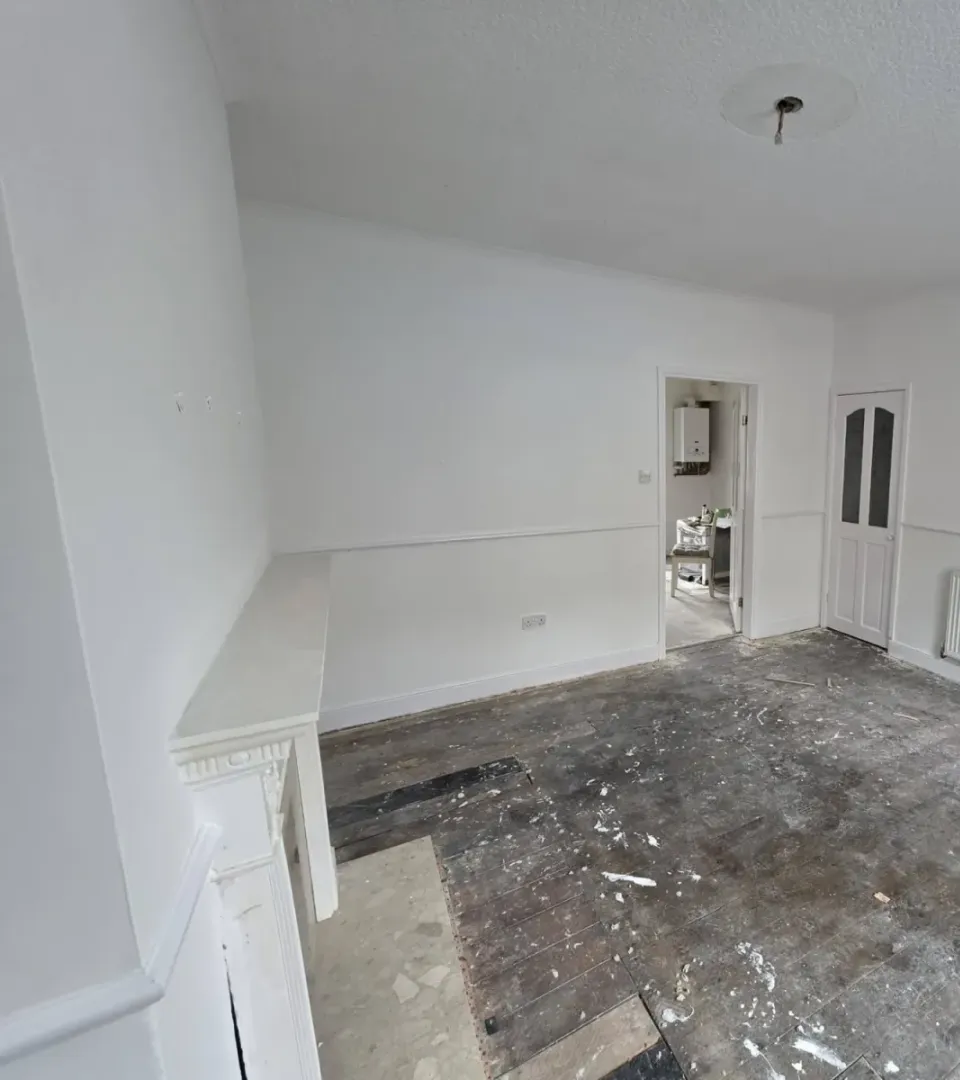 Freshly painted white living room with dado rail and fire surround
